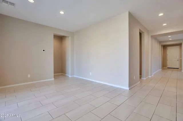 an empty room with closet and a chandelier fan
