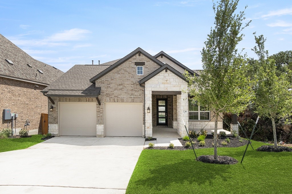 236 Heartleaf Road San Marcos, TX 78666 - Photo 1 of 1 a front view of house with a garden and patio