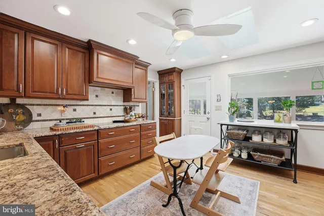 a kitchen with a cabinets appliances and a dining table