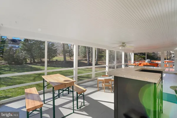 a patio with a table and chairs and garden