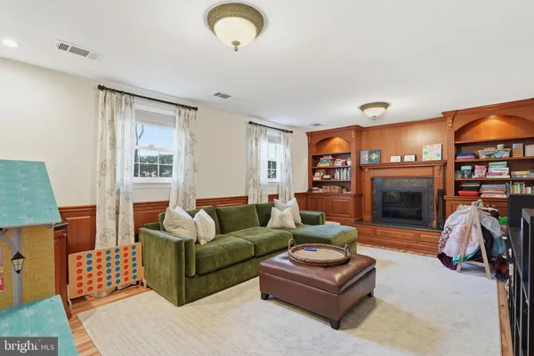 a living room with furniture a window and a fireplace