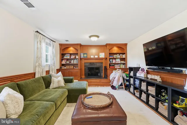 a living room with fireplace furniture and a flat screen tv
