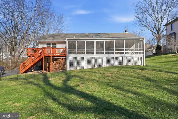 a view of a house with a yard and sitting area