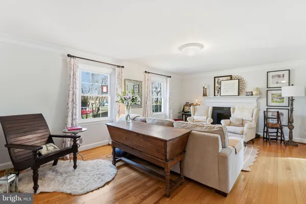 a living room with fireplace furniture and a wooden floor