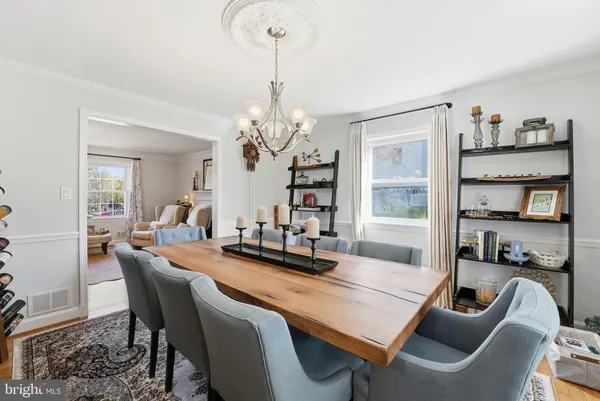 a dining room with furniture and a chandelier