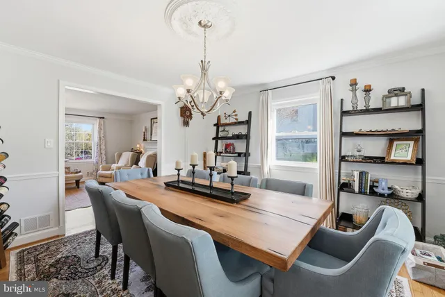 a dining room with furniture and a chandelier