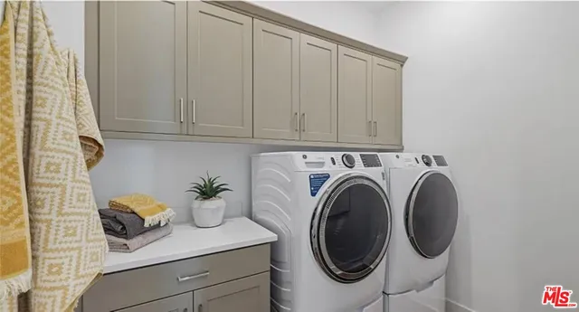 a living room with furniture a potted plant and kitchen view