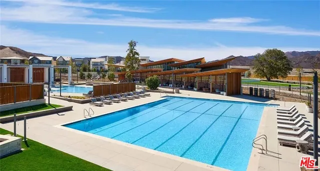 a view of a swimming pool with outdoor seating