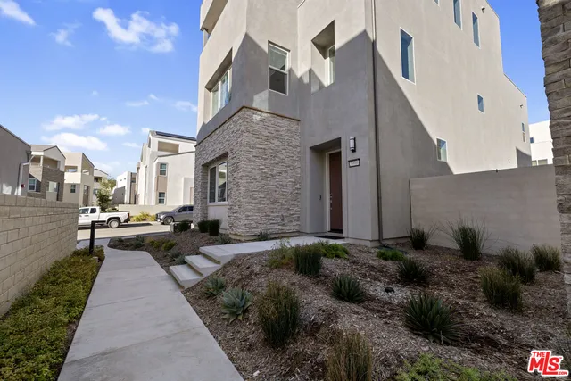 a pathway of a house with a yard