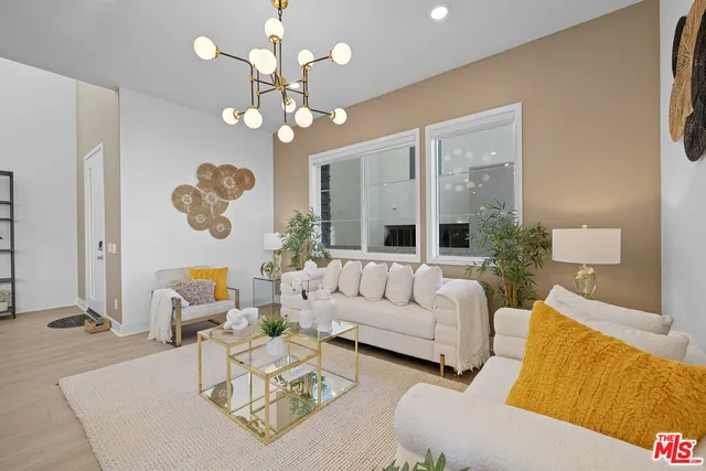 a dining room with furniture and kitchen view
