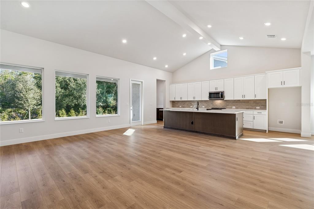 31479 Hayman Loop Wesley Chapel, FL 33545 - Photo 11 of 45 a large kitchen with stainless steel appliances granite countertop a large counter top a sink and a refrigerator