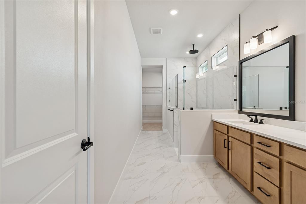 31479 Hayman Loop Wesley Chapel, FL 33545 - Photo 18 of 45 a bathroom with a double vanity sink mirror and double