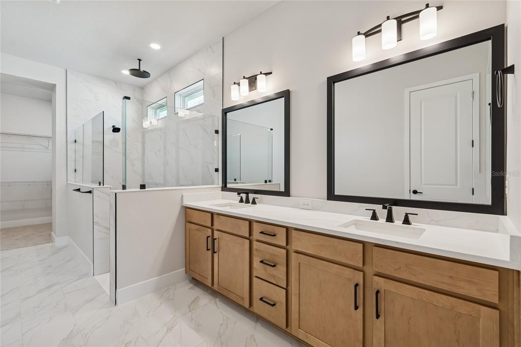 31479 Hayman Loop Wesley Chapel, FL 33545 - Photo 19 of 45 a bathroom with a double vanity sink mirror and double