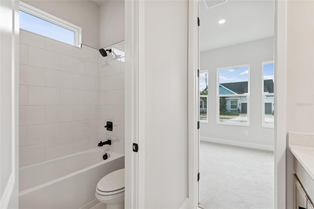 31479 Hayman Loop Wesley Chapel, FL 33545 - Photo 27 of 45 a bathroom with a toilet bathtub and shower