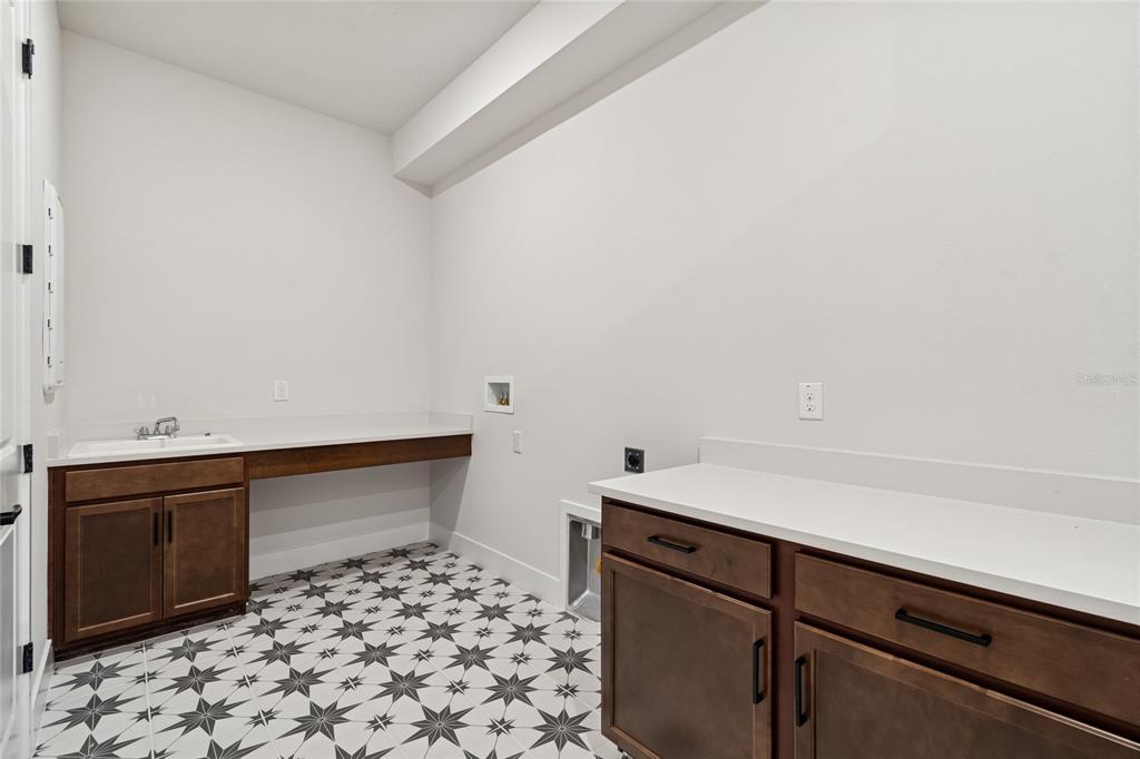 31479 Hayman Loop Wesley Chapel, FL 33545 - Photo 34 of 45 a room with a door and a cabinet