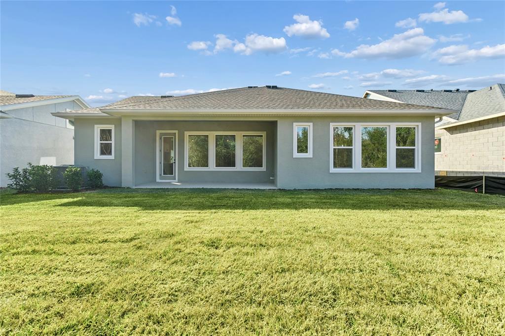 31479 Hayman Loop Wesley Chapel, FL 33545 - Photo 40 of 45 a view of a house with a backyard