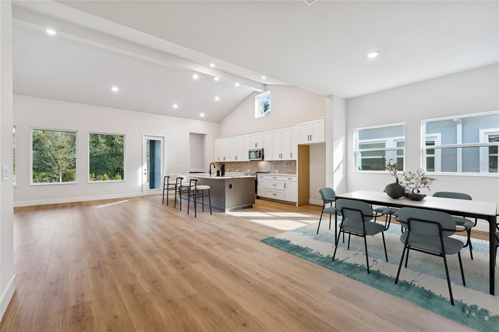 31479 Hayman Loop Wesley Chapel, FL 33545 - Photo 8 of 45 a view of a dining room with furniture window and wooden floor
