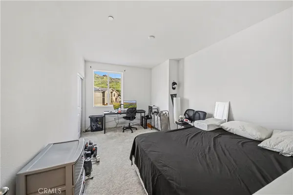 a living room with furniture and a baby crib
