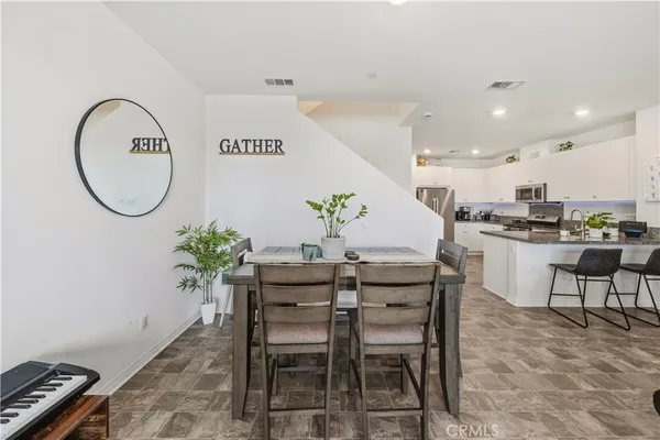 a kitchen with stainless steel appliances granite countertop a sink and a refrigerator