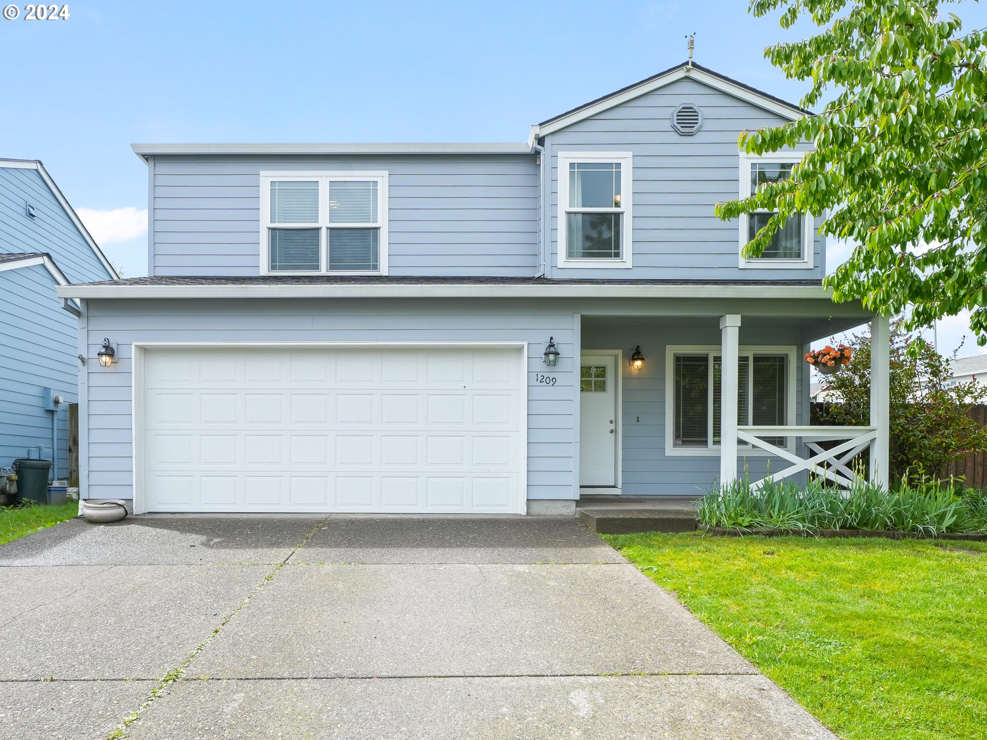 1209 Northeast 167th Street Ridgefield, WA 98642 - Photo 1 of 38 a front view of a house with garden
