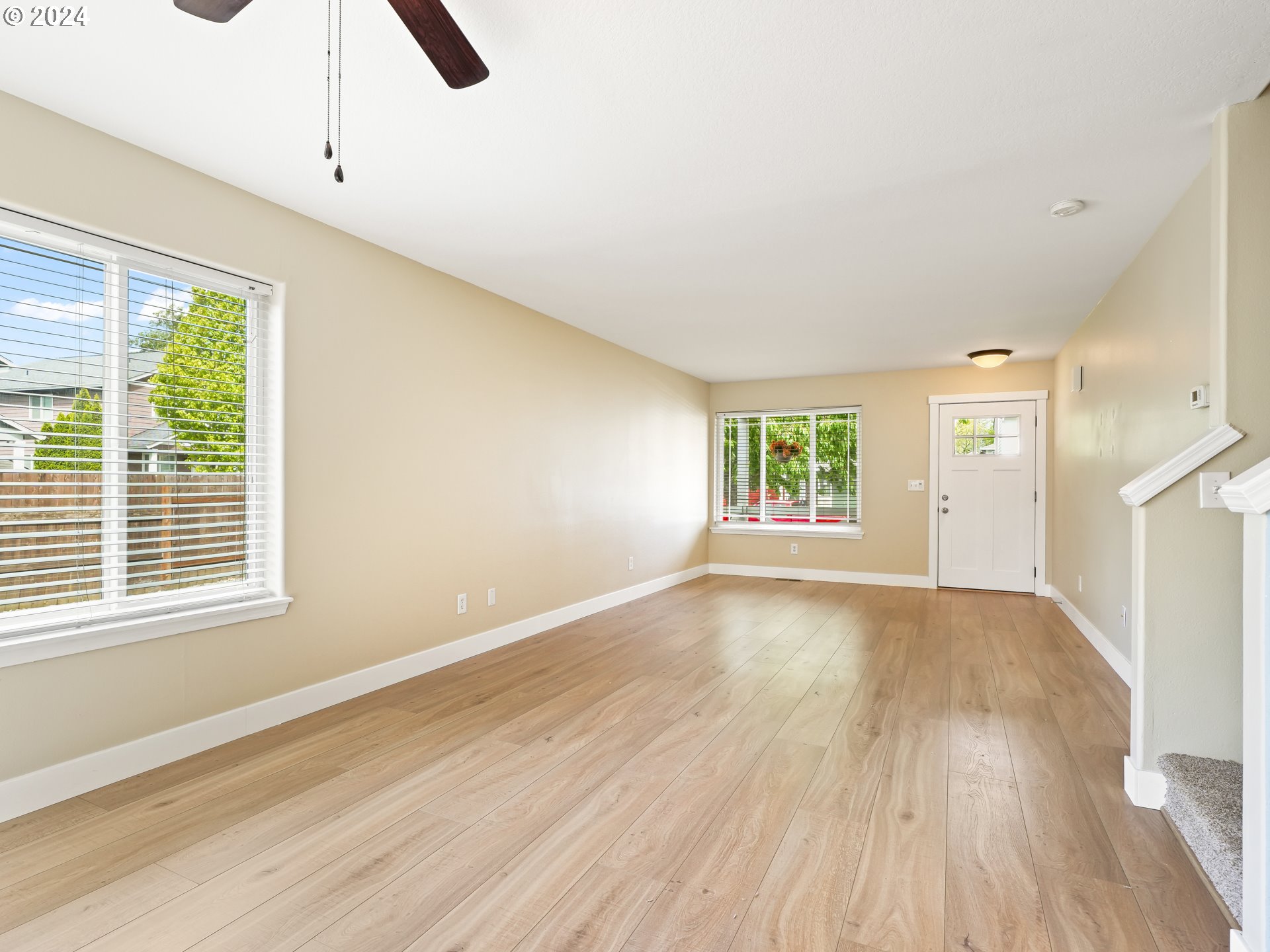 1209 Northeast 167th Street Ridgefield, WA 98642 - Photo 10 of 38 a view of an empty room with wooden floor and a window