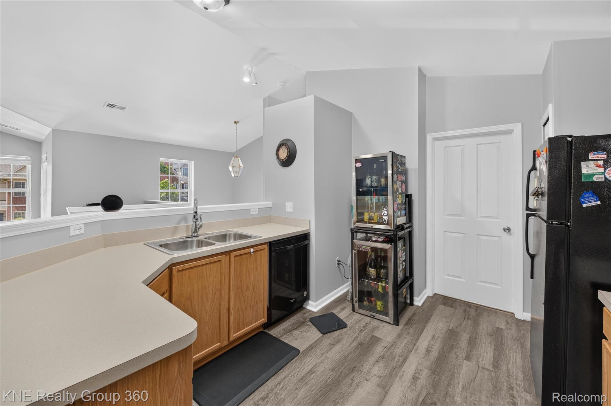 4077 Berkeley Avenue Canton, MI 48188 - Photo 11 of 32 Kitchen featuring wood-finish flooring, light tone countertops, wood cabinetry, and a double basin sink