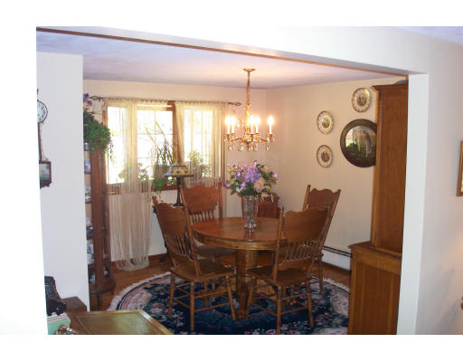 78 Dudley Road Sudbury, MA 01776 - Photo 6 of 7 a view of a dining room with furniture and chandelier