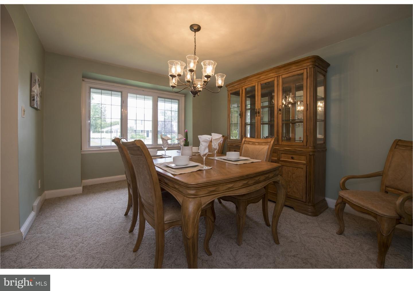 534 Kent Road Springfield, PA 19064 - Photo 5 of 24 a view of a dining room with furniture a chandelier and large windows