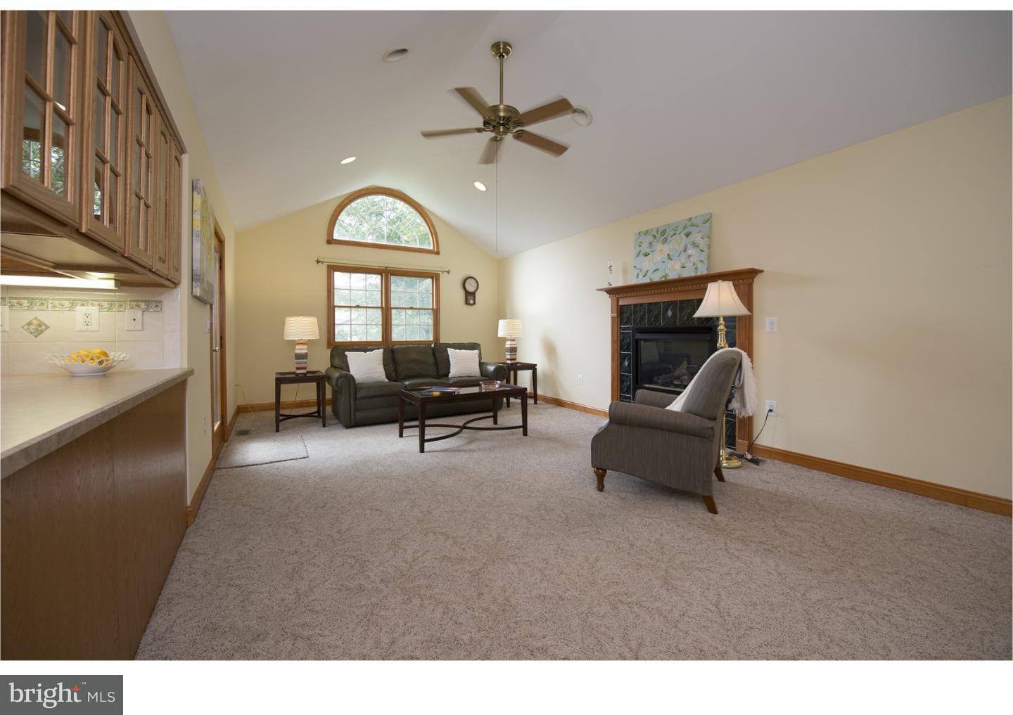534 Kent Road Springfield, PA 19064 - Photo 8 of 24 a living room with furniture a fireplace and a chandelier