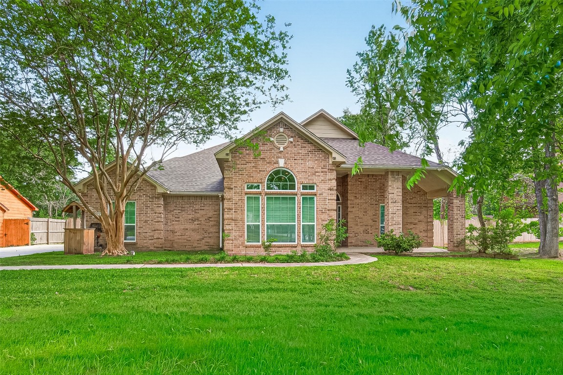 This traditional custom-built home features brick on all sides and side entry garage and and mature trees in the front yard.   The front patio is ready for some comfy furniture to sit on and wave at the neighbors on their golf carts.