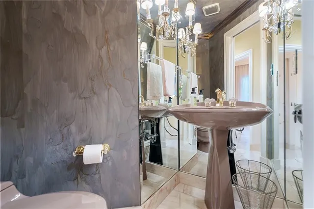 a bathroom with a sink two mirror and a toilet