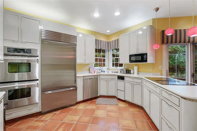 a kitchen with a sink stainless steel appliances and cabinets