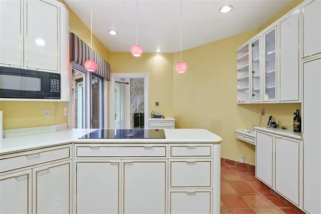 a kitchen with a sink cabinets and wooden floor