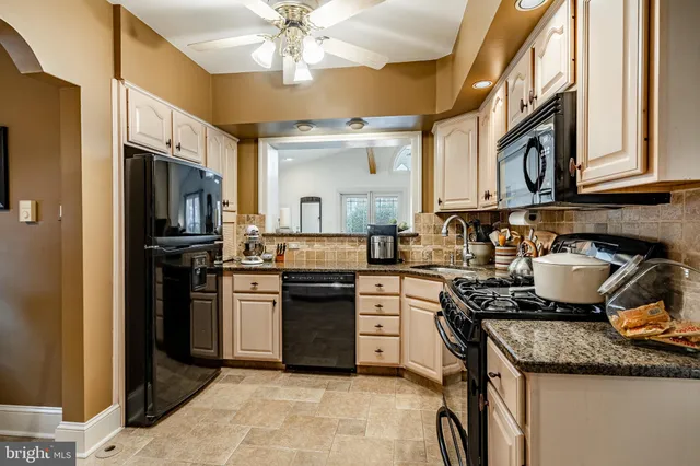 a kitchen with stainless steel appliances granite countertop a stove and a refrigerator