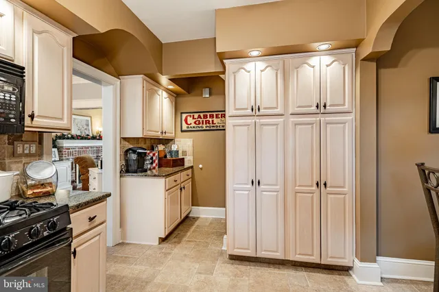 a dining room with furniture a chandelier and wooden floor