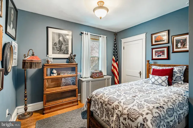 a bedroom with a bed and dresser with mirror