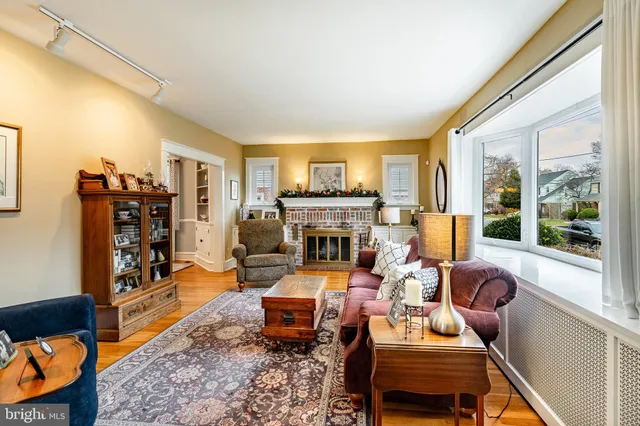 a living room with furniture fireplace and a large window