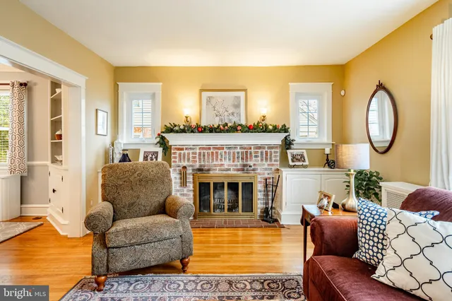 a living room with furniture a chandelier and a flat screen tv