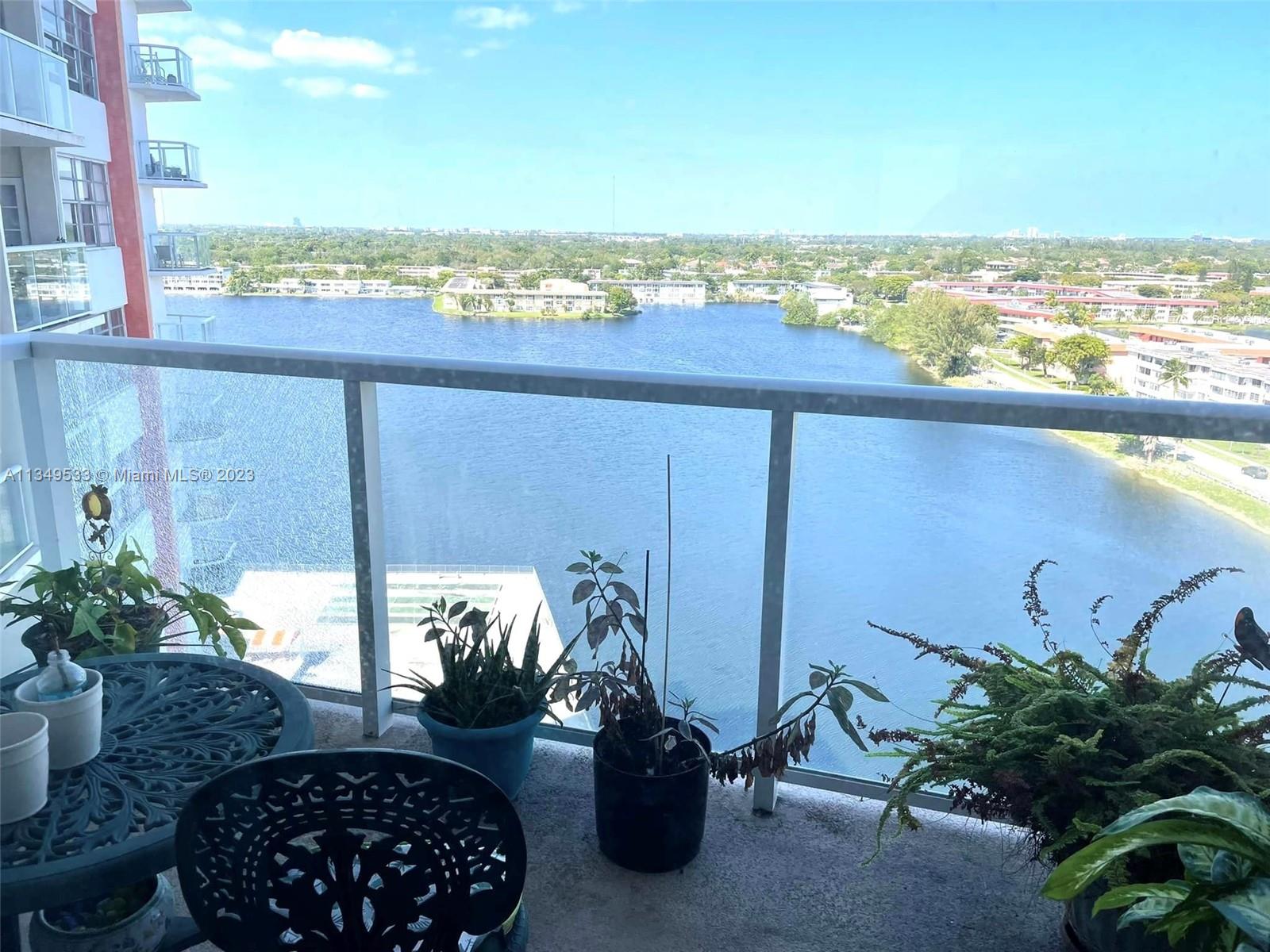 a view of a balcony with lake view and a potted plant