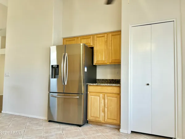 a kitchen with stainless steel appliances a refrigerator and a cabinets