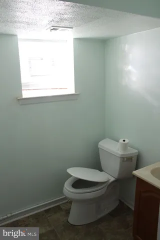 a white toilet sitting next to a window
