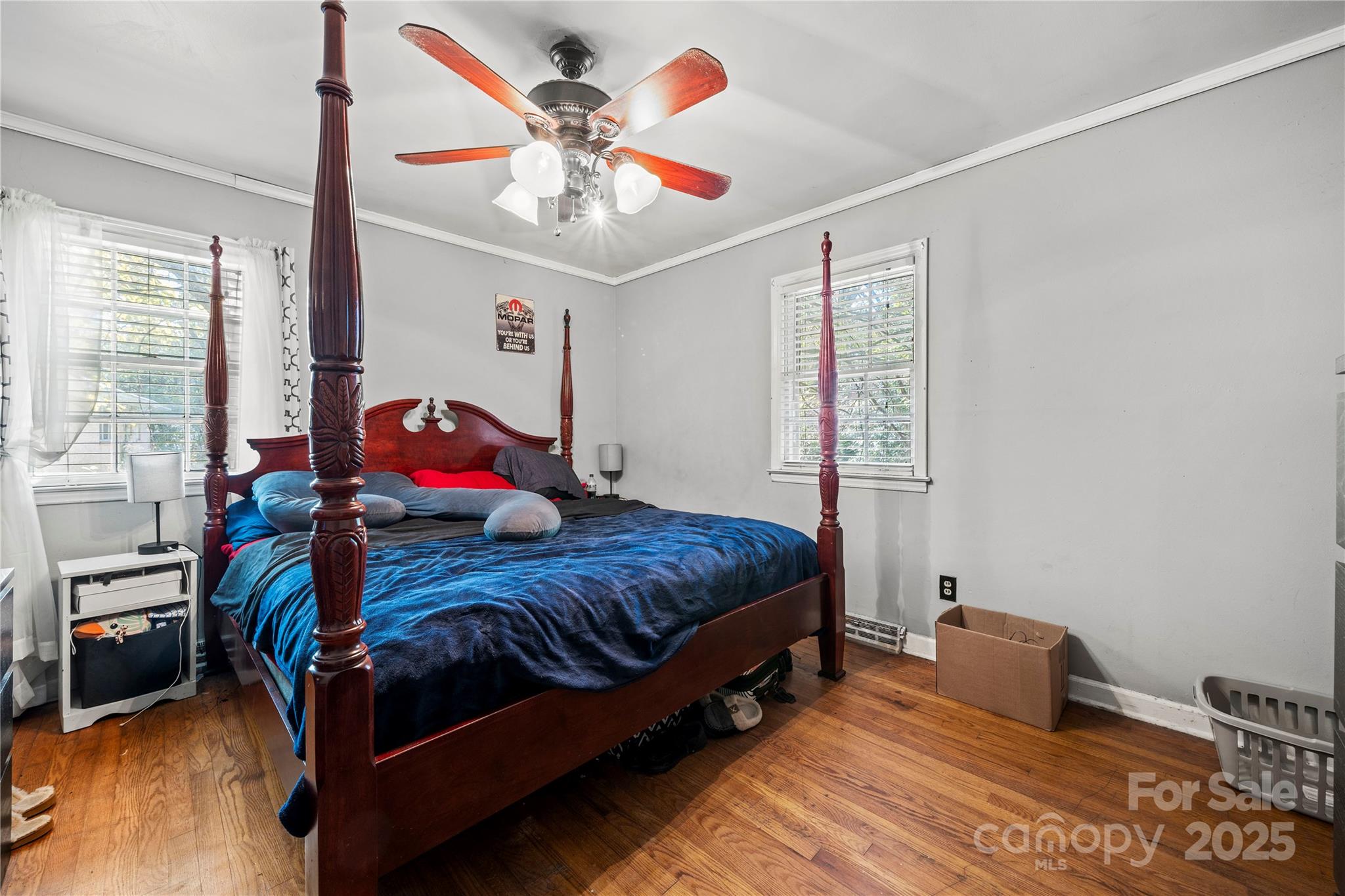 4838 Hidden Valley Road Charlotte, NC 28213 - Photo 15 of 22 a bedroom with a bed and a chandelier