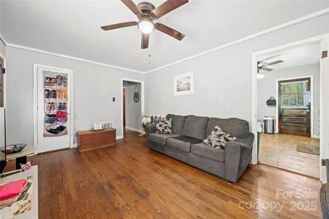 a living room with furniture and a wooden floor