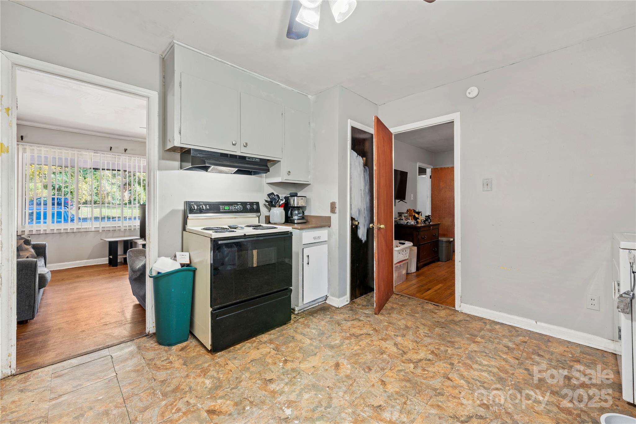 4838 Hidden Valley Road Charlotte, NC 28213 - Photo 7 of 22 a kitchen with a stove a refrigerator and a stove top oven