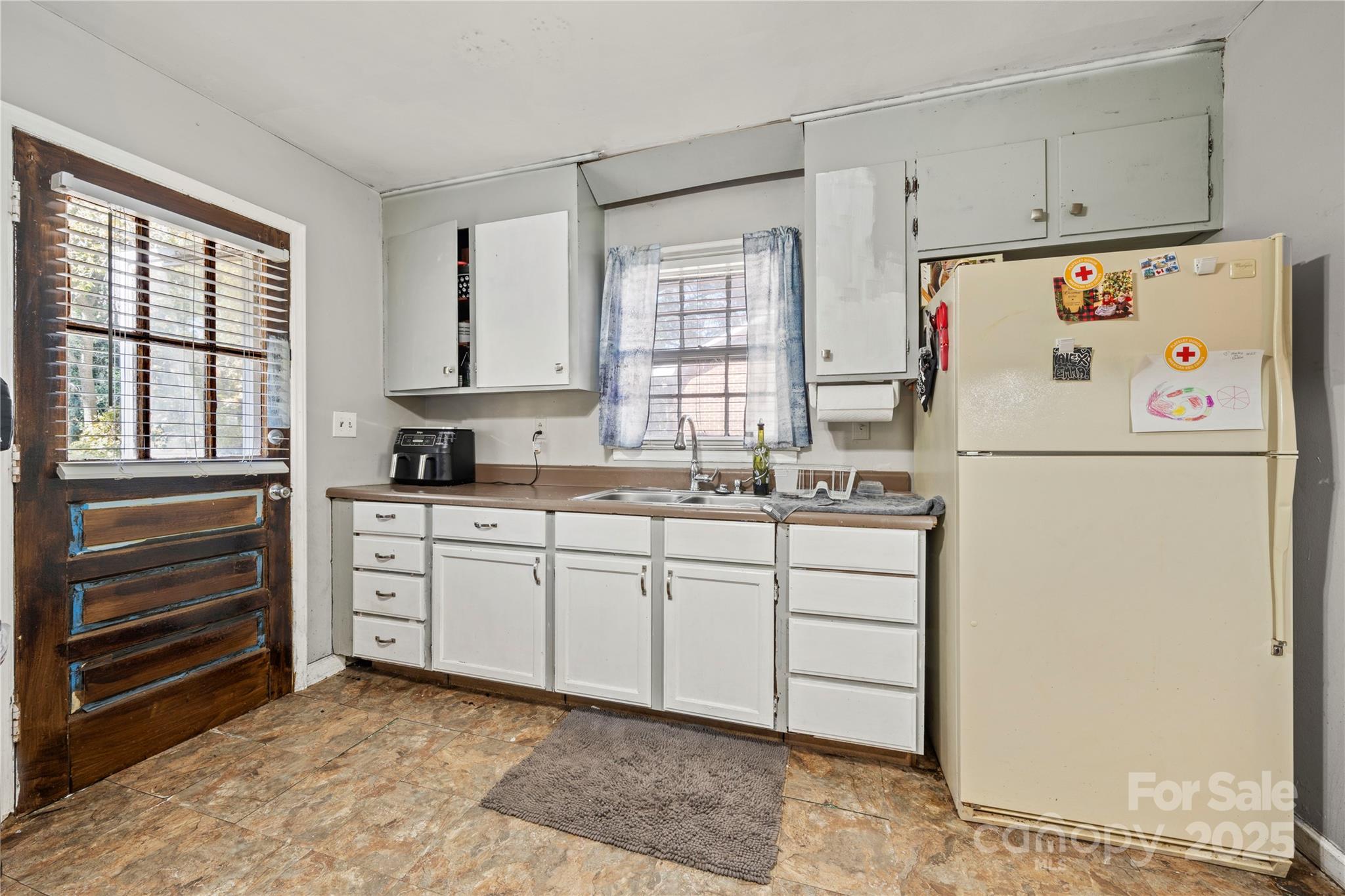 4838 Hidden Valley Road Charlotte, NC 28213 - Photo 8 of 22 a white refrigerator freezer sitting in a kitchen