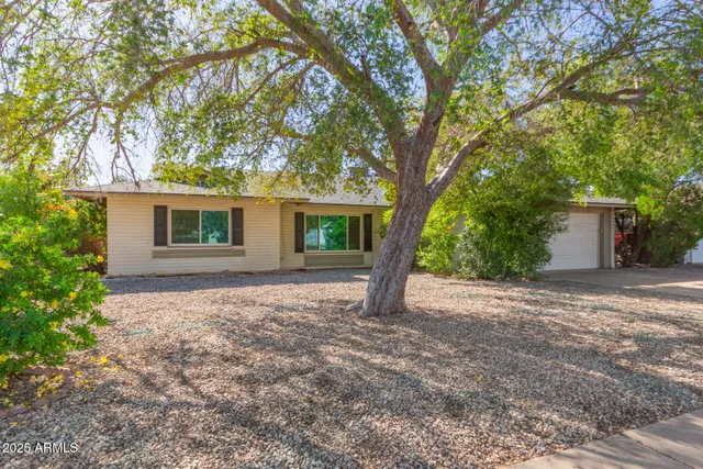 a view of a house with a tree in front