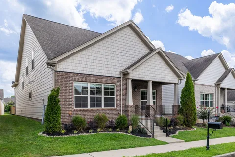 a front view of a house with a yard and porch