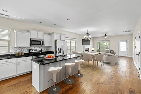a kitchen with stainless steel appliances granite countertop a sink and window