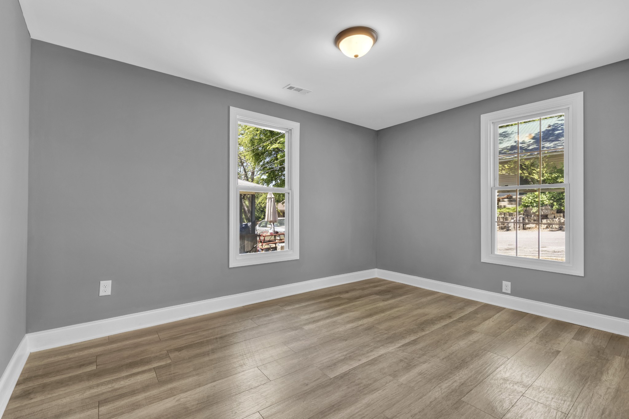 223 East 4th Avenue Springfield, TN 37172 - Photo 10 of 13 an empty room with wooden floor and windows