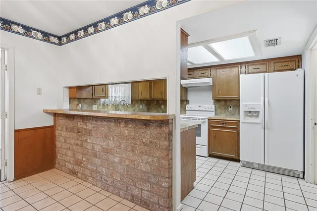 a kitchen with a stove sink and cabinets